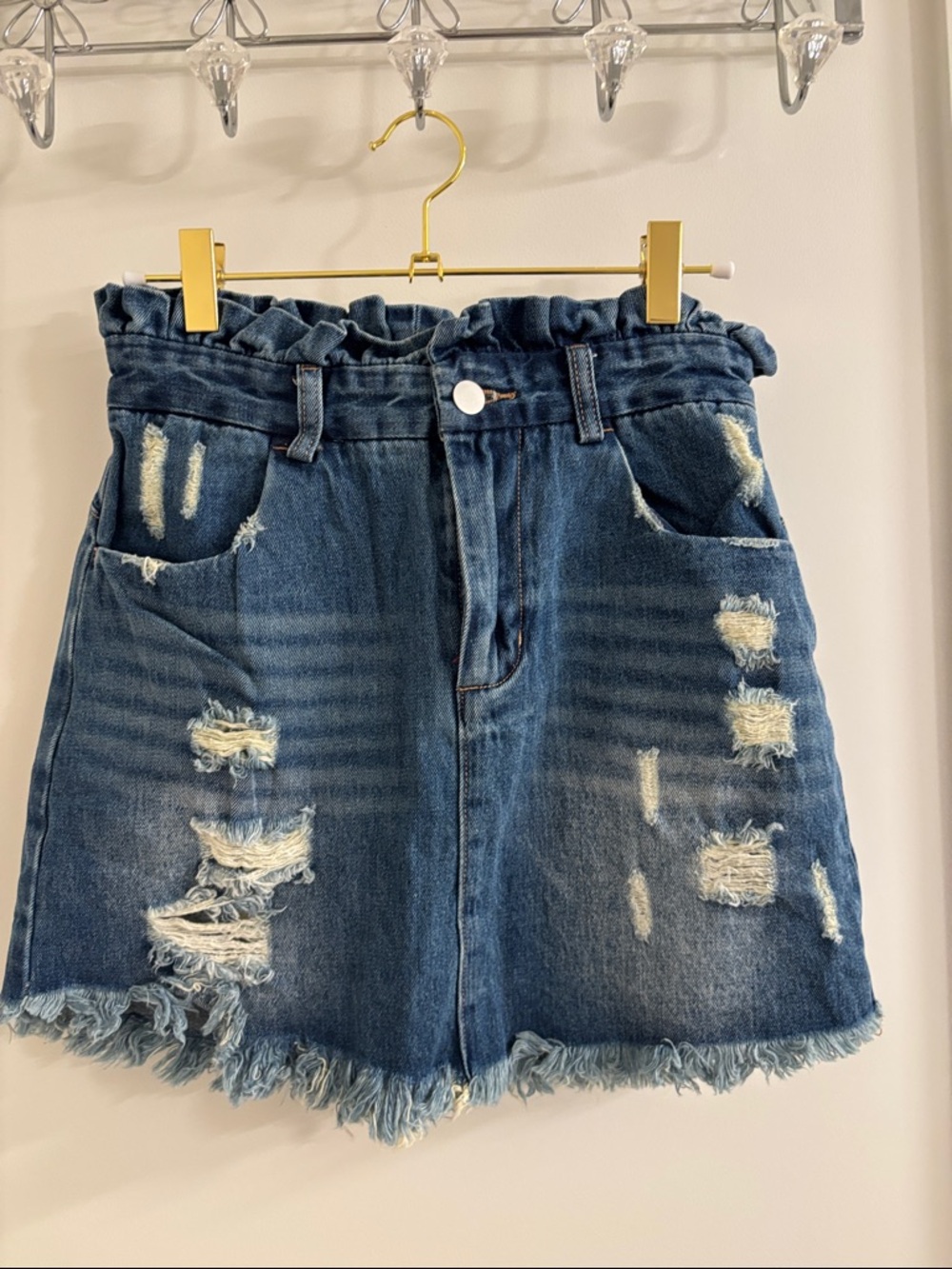 High-Rise Distressed Denim Mini Skirt in Blue